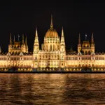 Hungarian Parliament illuminated at night by the Danube