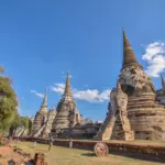 Ancient brick temple ruins of Ayutthaya under blue sky