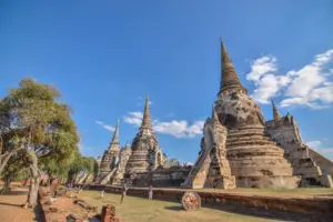 Ancient brick temple ruins of Ayutthaya under blue sky