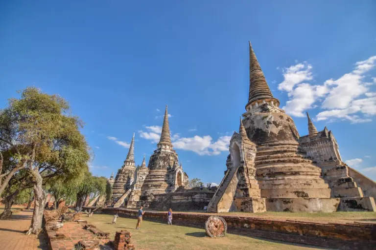 Ancient brick temple ruins of Ayutthaya under blue sky
