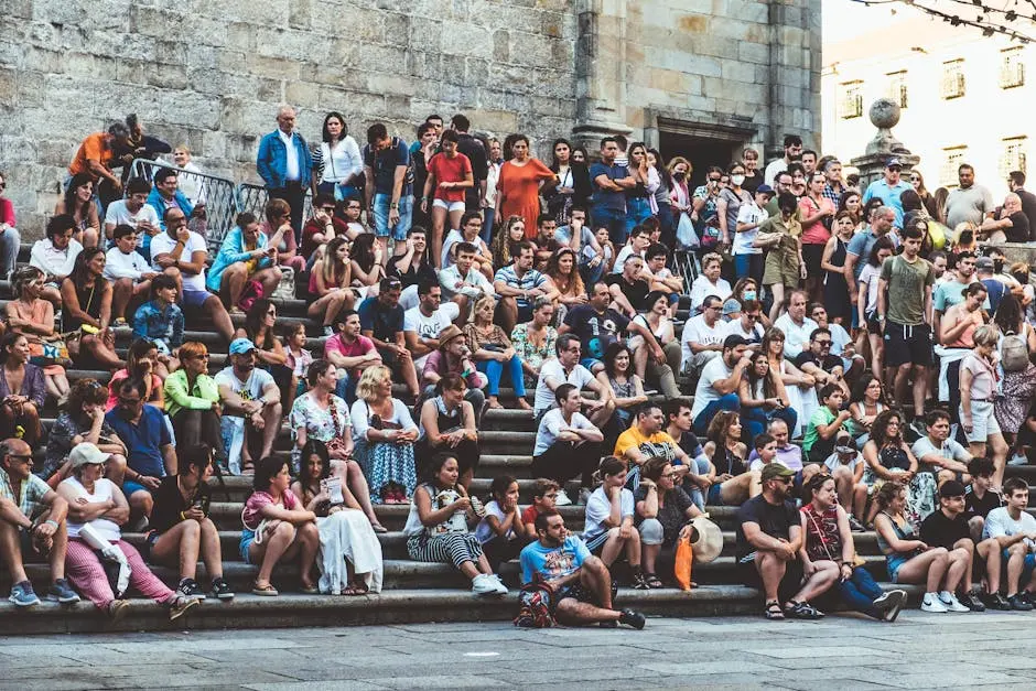 Large group of people sitting on stone steps