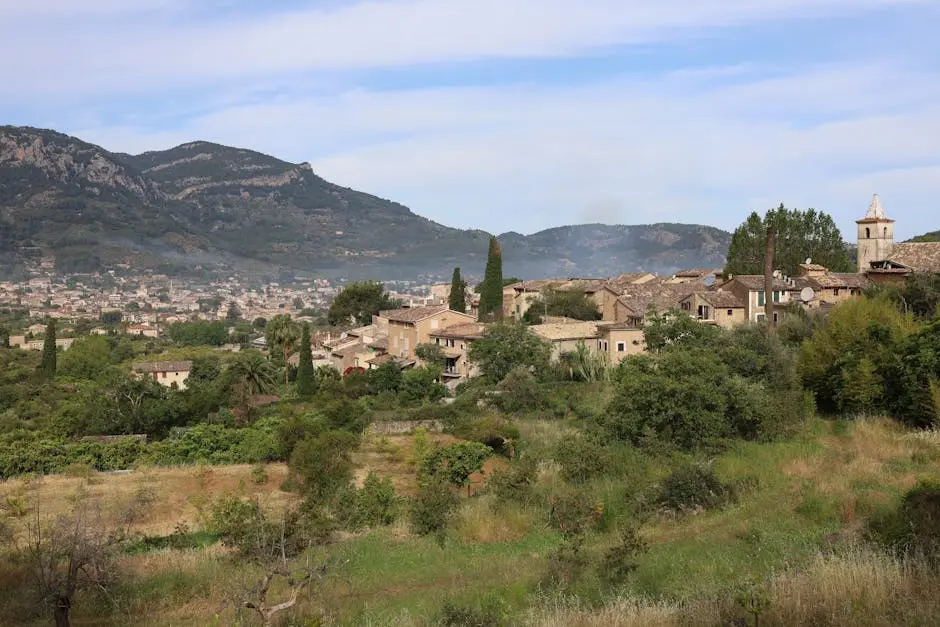 Mallorcan village among trees below the Tramuntana mountains