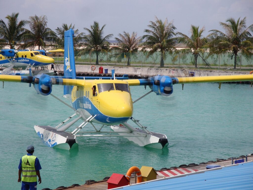 A seaplane landing on a turquoise lagoon in the Maldives