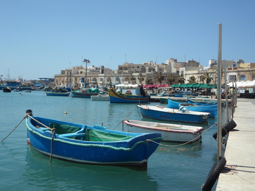 Colourful luzzu fishing boats in the harbour of Marsaxlokk, Malta