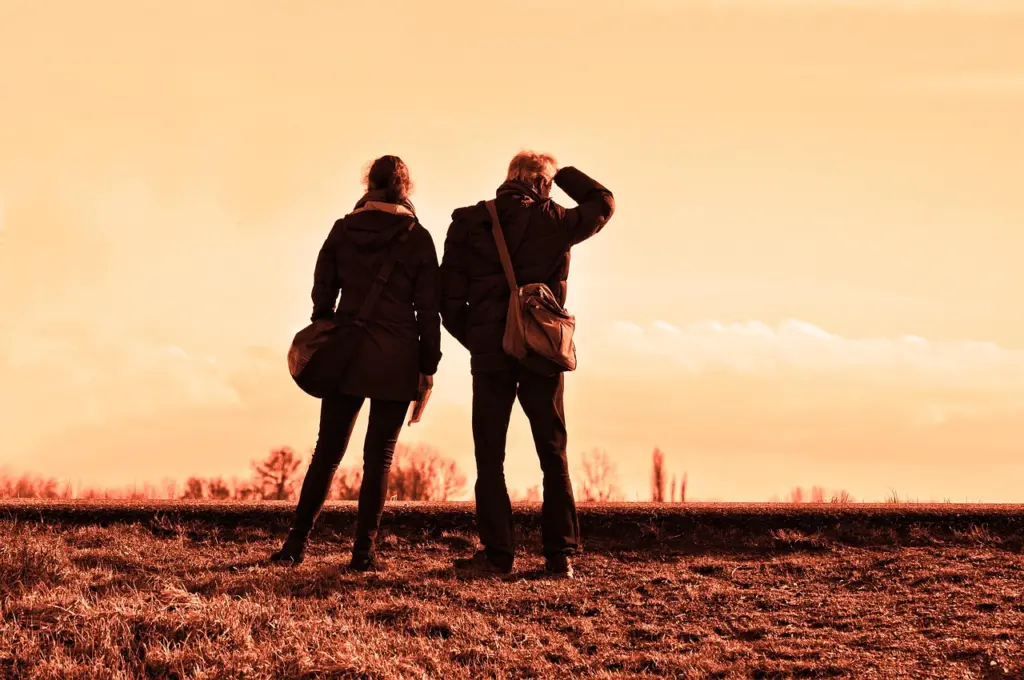 Couple looking out over the landscape at sunset