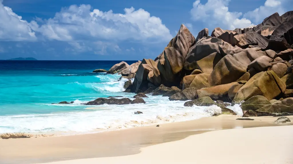 Granite boulders and white sand on a beach in the Seychelles