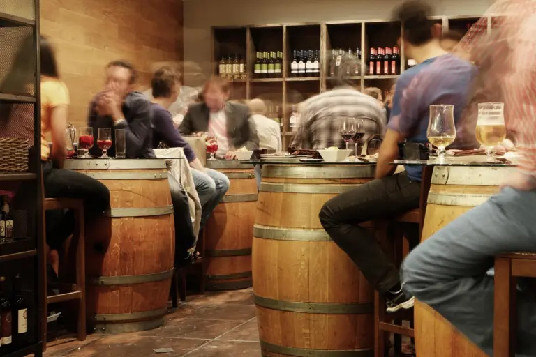 Guests at barrel tables in a tapas bar in Madrid