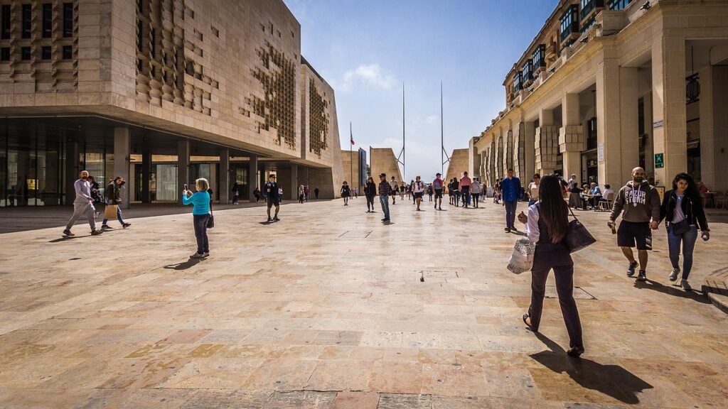 Pedestrians at Valletta City Gate near the Parliament building, Malta