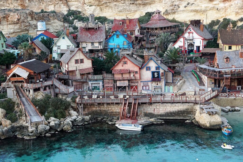 Rustic wooden houses of Popeye Village at Anchor Bay, Malta