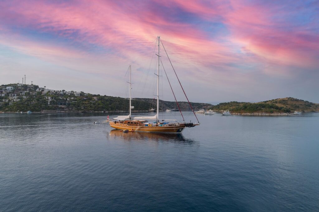 Sailing boat off the coast of Alacati at dusk, Turkey