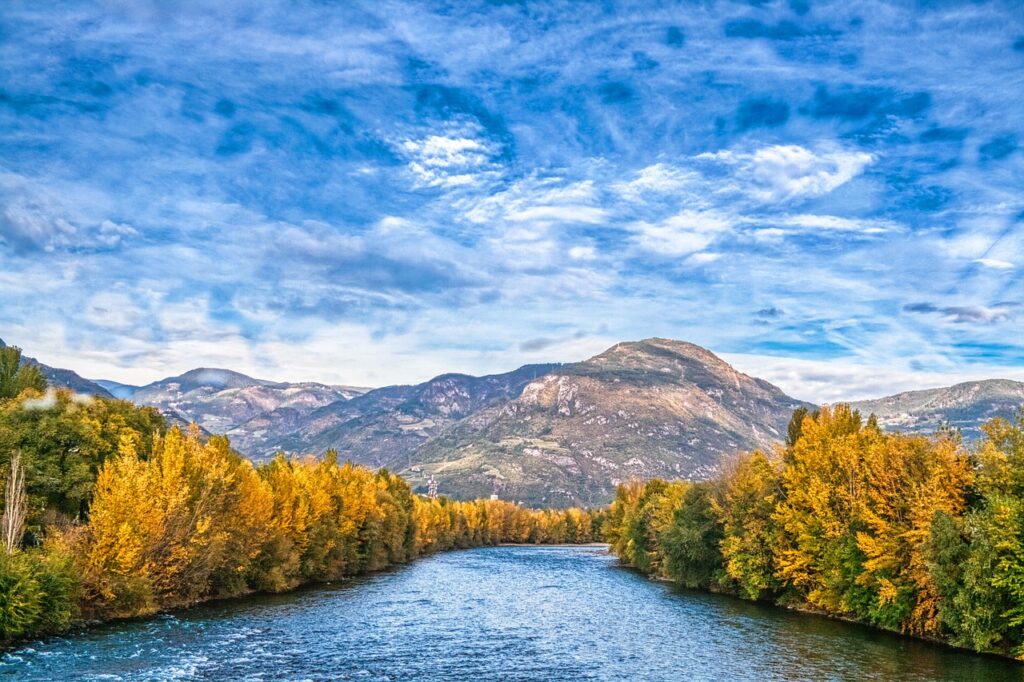 Stream among trees and mountains near Bolzano, South Tyrol