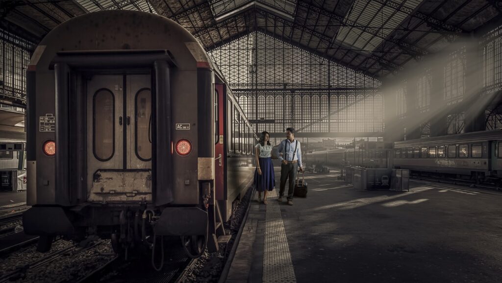 Travellers with luggage waiting at a train station platform